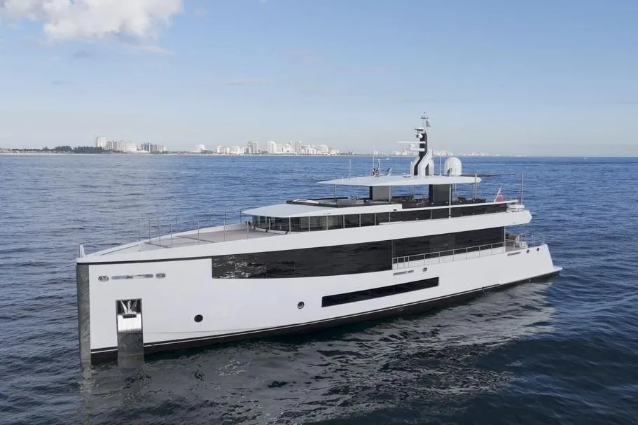2016 Feadship Lagoon Cruiser (FLC) yacht on open sea with city skyline in background.