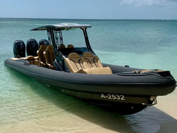  Yacht Photos Pics 2018 Bernico RX10 boat with triple engines, anchored on a sandy beach with clear blue water.
