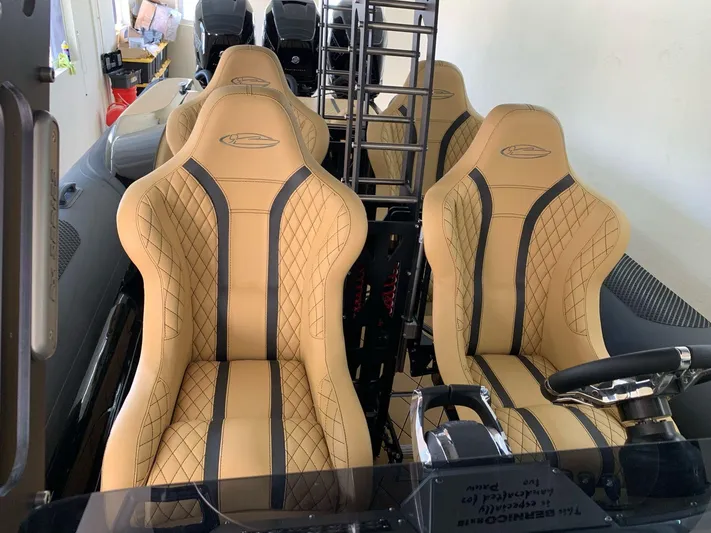  Yacht Photos Pics Luxurious interior of a 2018 Bernico RX10 boat with tan leather seats.