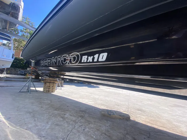  Yacht Photos Pics 2018 Bernico RX10 boat on dry dock, showcasing sleek black hull design.
