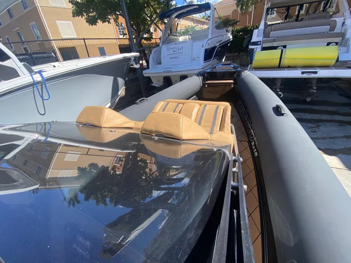  Yacht Photos Pics 2018 Bernico RX10 boat with tan seats, docked alongside other boats.