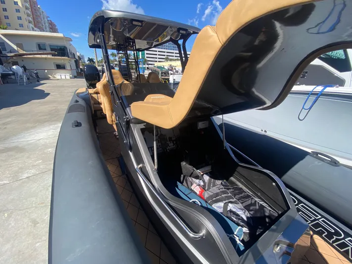  Yacht Photos Pics 2018 Bernico RX10 boat with tan seats and sleek design docked under clear blue sky.