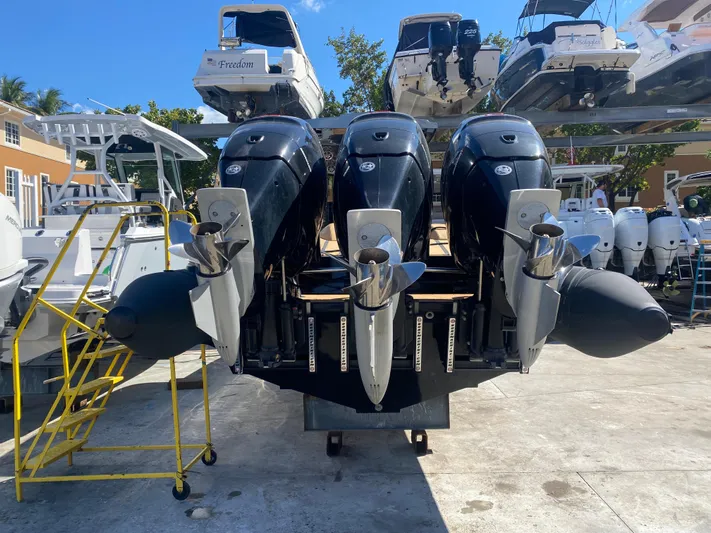  Yacht Photos Pics Three powerful outboard motors on a 2018 Bernico RX10 boat in a marina.