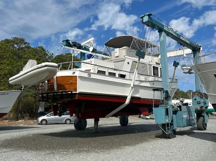  Yacht Photos Pics Grand Banks 49 Classic yacht from 1997 being lifted by a boat hoist.