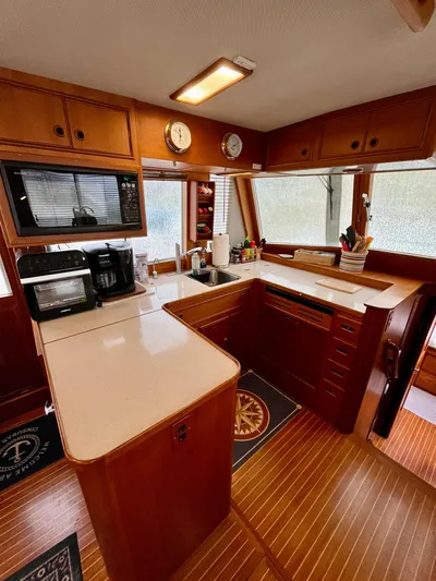 Yacht Photos Pics 1997 Grand Banks 49 Classic yacht kitchen with wood cabinetry and modern appliances.