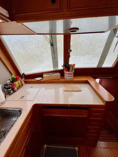  Yacht Photos Pics 1997 Grand Banks 49 Classic yacht kitchen with wooden cabinetry and countertop.