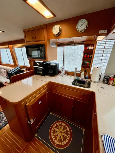  Yacht Photos Pics Interior of 1997 Grand Banks 49 Classic yacht kitchen with wood cabinetry and modern appliances.