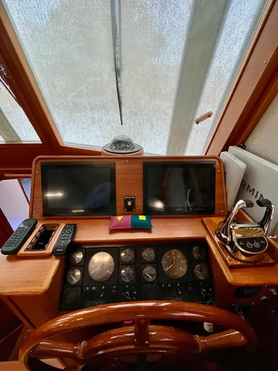  Yacht Photos Pics Helm of 1997 Grand Banks 49 Classic yacht with navigation instruments and wooden steering wheel.