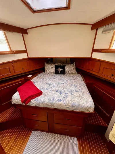  Yacht Photos Pics Cozy bedroom in 1997 Grand Banks 49 Classic yacht with wooden cabinetry and skylight.