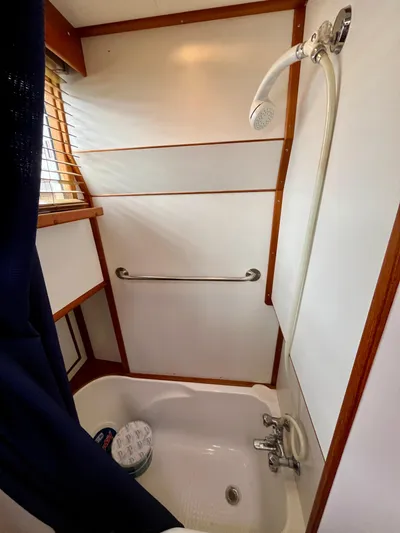  Yacht Photos Pics Shower area in 1997 Grand Banks 49 Classic yacht with wooden accents and handheld showerhead.