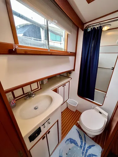  Yacht Photos Pics Bathroom interior of a 1997 Grand Banks 49 Classic yacht, featuring a sink, toilet, and shower.
