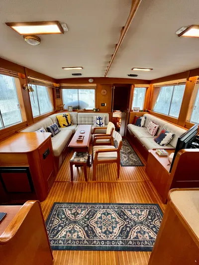  Yacht Photos Pics Interior of a 1997 Grand Banks 49 Classic yacht with elegant wood finish and cozy seating.