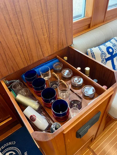  Yacht Photos Pics Storage compartment with glasses and bottles on a 1997 Grand Banks 49 Classic yacht.