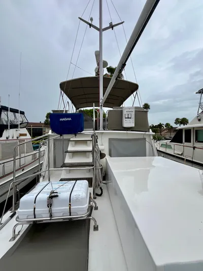  Yacht Photos Pics 1997 Grand Banks 49 Classic yacht deck with equipment and canopy, docked at marina.