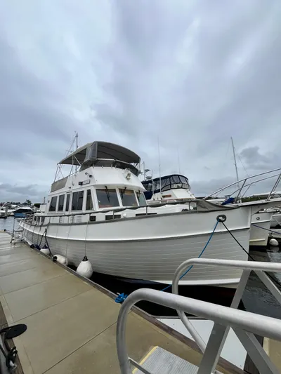  Yacht Photos Pics 1997 Grand Banks 49 Classic yacht docked at marina under cloudy sky.