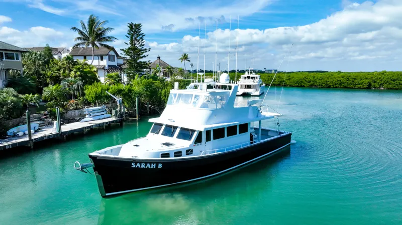 Sarah B Yacht Photos Pics Custom Carolina 58 Dixon Marine yacht, 2007, docked in a serene tropical setting.