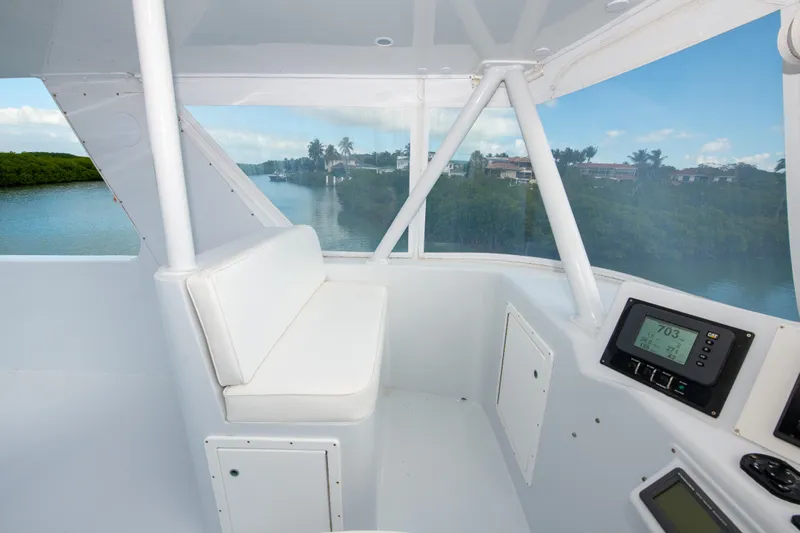 Sarah B Yacht Photos Pics Interior view of 2007 Custom Carolina 58 Dixon Marine boat with white seating and navigation equipment.