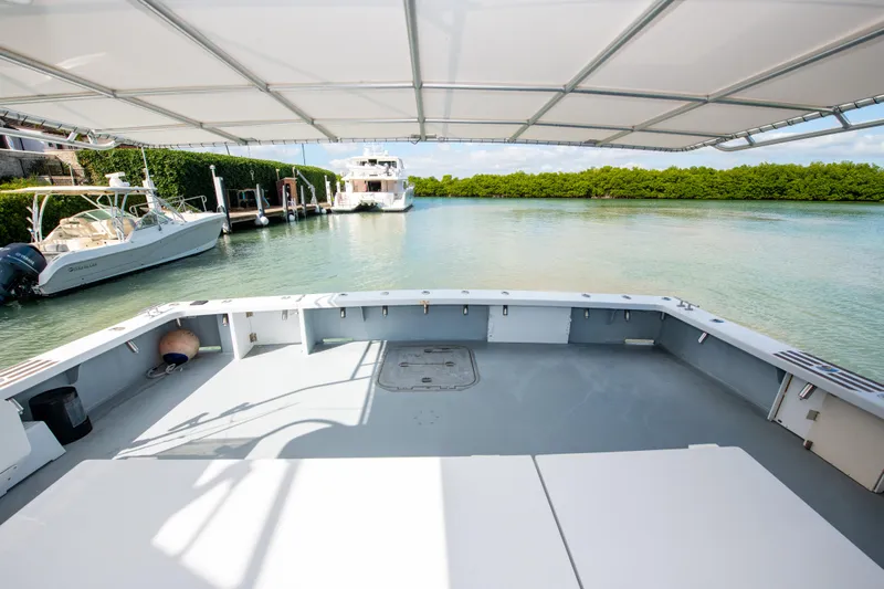 Sarah B Yacht Photos Pics Custom Carolina 58 Dixon Marine 2007 yacht docked in serene waters, shaded deck view.