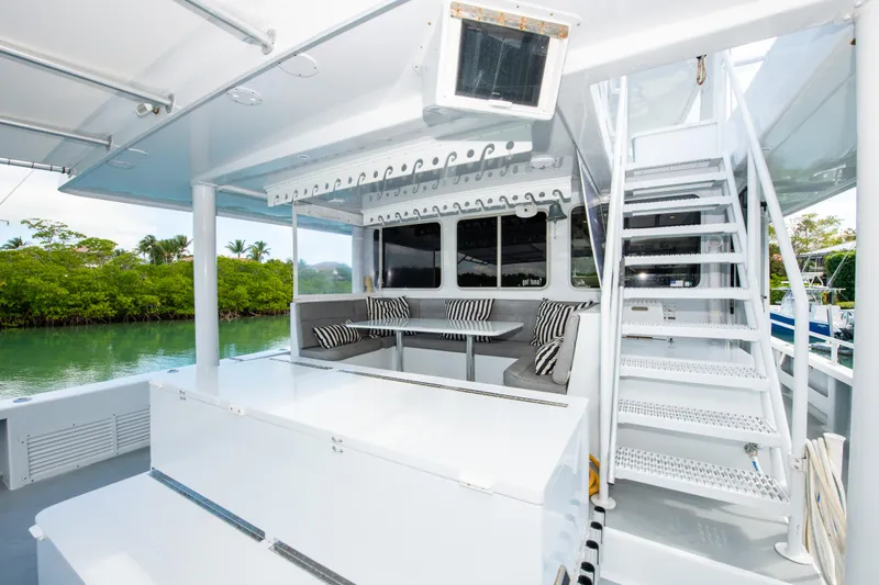 Sarah B Yacht Photos Pics Custom Carolina 58 Dixon Marine 2007 yacht with seating area and stairs, docked by lush greenery.