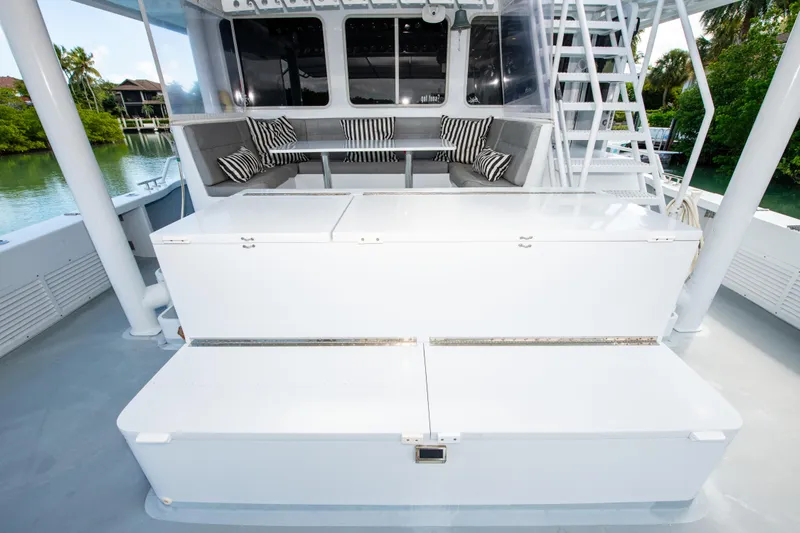 Sarah B Yacht Photos Pics Custom Carolina 58 Dixon Marine 2007 yacht interior with seating and storage, featuring striped cushions.