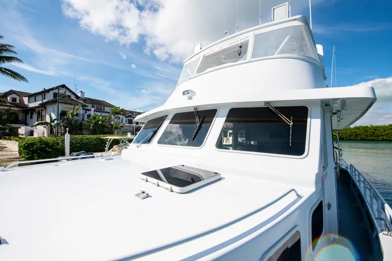 Sarah B Yacht Photos Pics Custom Carolina 58 Dixon Marine yacht, 2007 model, docked near waterfront homes under a clear sky.