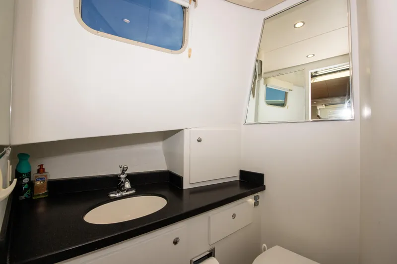 Sarah B Yacht Photos Pics Bathroom interior of 2007 Custom Carolina 58 Dixon Marine yacht, featuring sink and mirror.