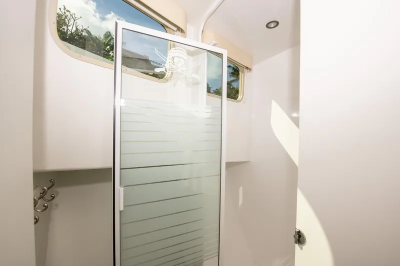 Sarah B Yacht Photos Pics Shower area in 2007 Custom Carolina 58 Dixon Marine yacht, featuring frosted glass door.