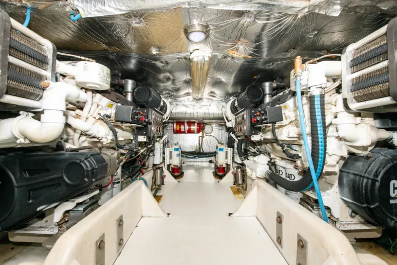 Sarah B Yacht Photos Pics Engine room of 2007 Custom Carolina 58 Dixon Marine yacht, showcasing dual engines and mechanical systems.