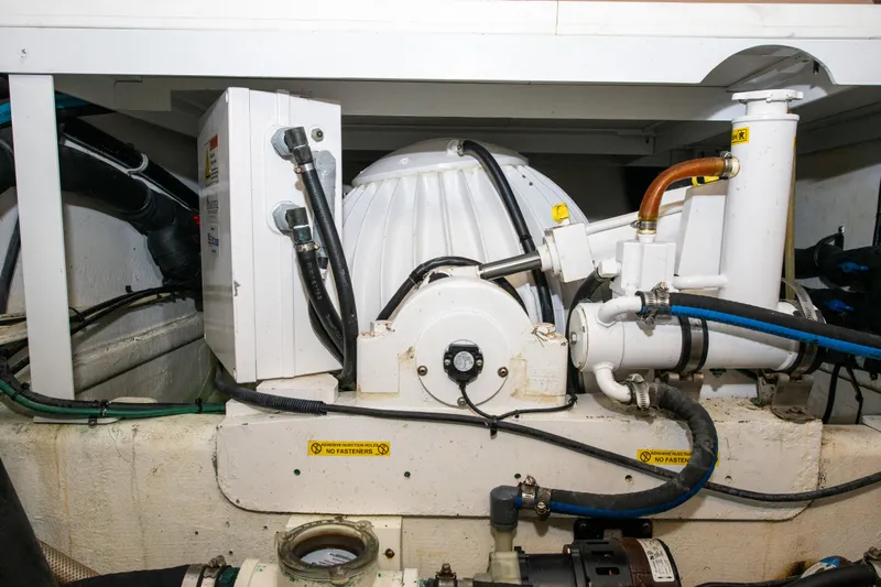 Sarah B Yacht Photos Pics Engine room of 2007 Custom Carolina 58 Dixon Marine boat, showcasing mechanical components.