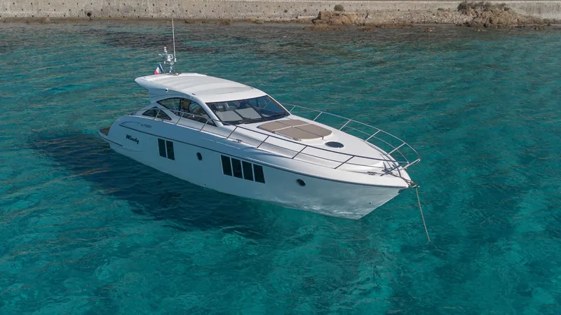 Tyma Yacht Photos Pics 2019 Windy 46 Chinook yacht on clear turquoise water, showcasing sleek design and luxury.