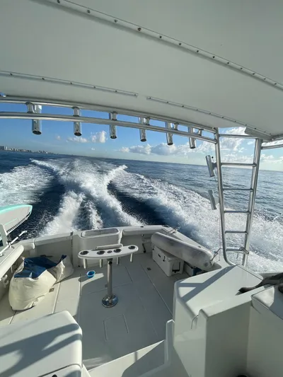  Yacht Photos Pics 2001 Cabo 35 Express boat cruising on open water, leaving a wake behind.