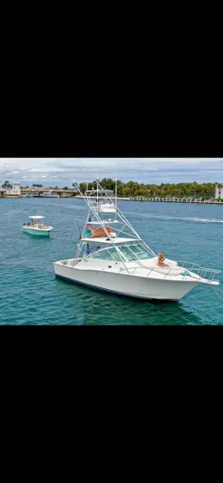  Yacht Photos Pics 2001 Cabo 35 Express boat cruising on a scenic waterway.
