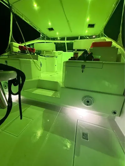  Yacht Photos Pics 2001 Cabo 35 Express boat interior with green lighting and seating area.