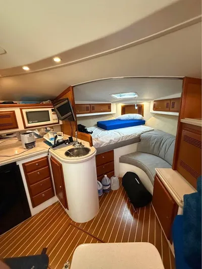  Yacht Photos Pics 2001 Cabo 35 Express cabin interior with kitchenette, bed, and seating area.