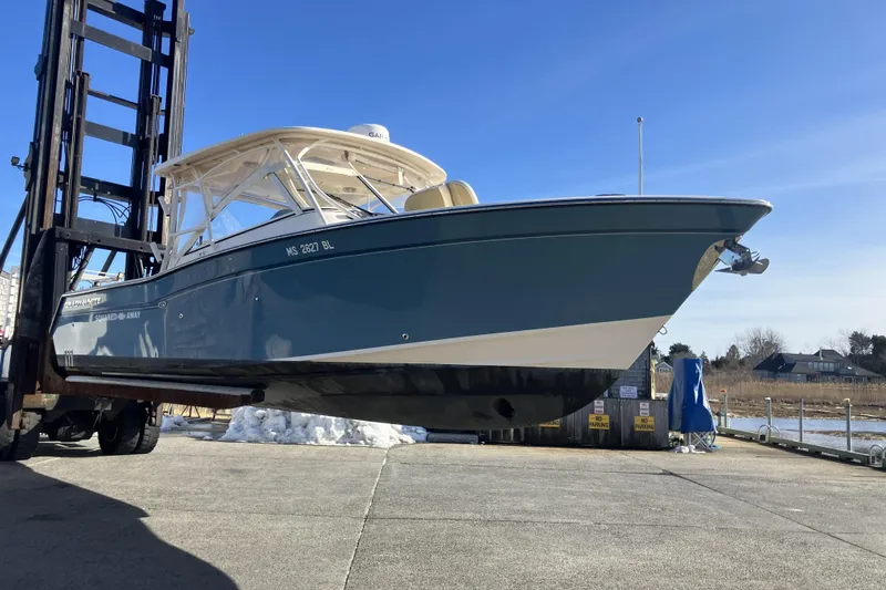  Yacht Photos Pics 2019 Grady-White Freedom 307 boat on forklift, dockside under clear blue sky.