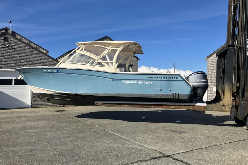  Yacht Photos Pics 2019 Grady-White Freedom 307 boat on forklift, blue hull, Yamaha engines, sunny day.