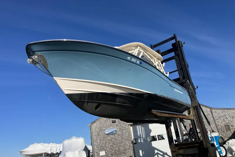  Yacht Photos Pics 2019 Grady-White Freedom 307 boat lifted against clear blue sky.