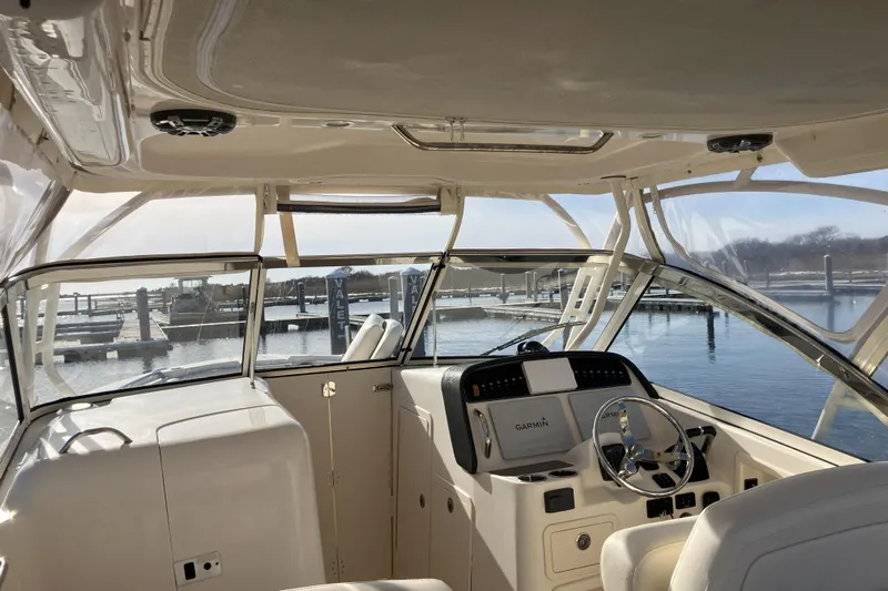  Yacht Photos Pics 2019 Grady-White Freedom 307 boat interior with Garmin navigation, docked at marina.