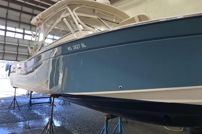  Yacht Photos Pics 2019 Grady-White Freedom 307 boat in a garage, elevated on stands.