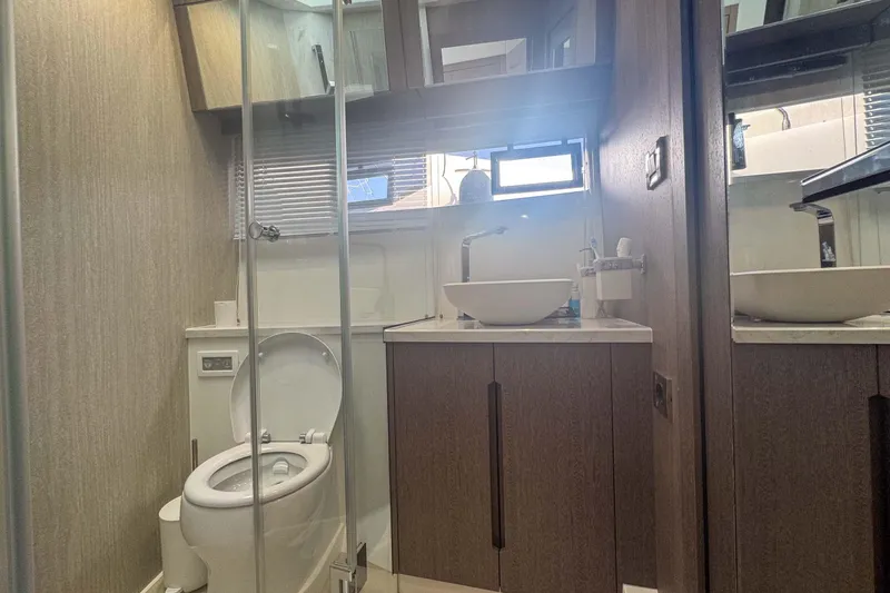 Sea Star Yacht Photos Pics Modern bathroom in 2023 Galeon 500 Fly yacht with sleek fixtures and wooden cabinetry.