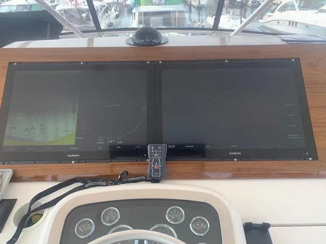  Yacht Photos Pics Control panel of a 2002 Viking 55 Convertible yacht with dual Garmin displays.