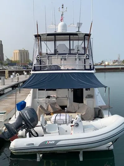  Yacht Photos Pics 2002 Viking 55 Convertible yacht docked with inflatable boat attached.