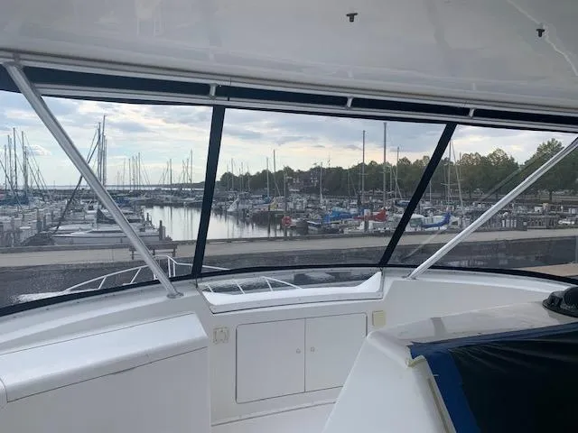  Yacht Photos Pics View from 2002 Viking 55 Convertible yacht overlooking marina with sailboats and calm water.