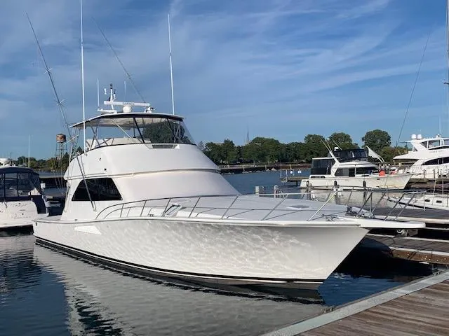  Yacht Photos Pics 2002 Viking 55 Convertible yacht docked at marina under clear blue sky.
