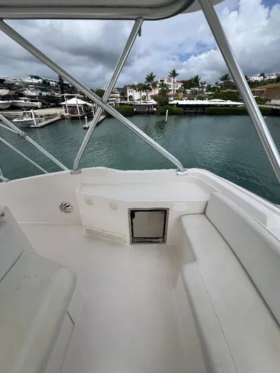 No Name Yacht Photos Pics 2009 Bertram 45 Convertible boat deck with seating, overlooking a serene waterfront view.