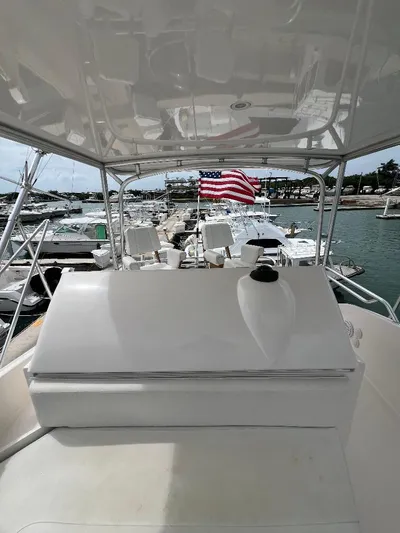 No Name Yacht Photos Pics 2009 Bertram 45 Convertible yacht docked, featuring a spacious deck and American flag.