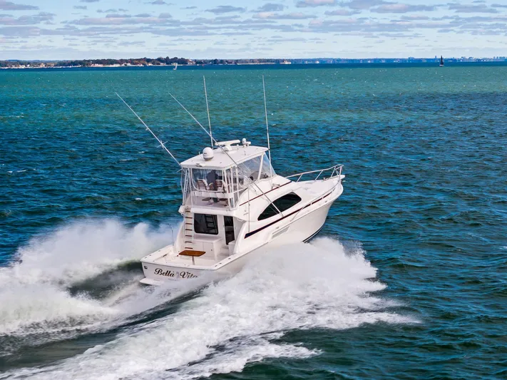 Bella Vita Yacht Photos Pics 2010 Bertram Convertible yacht cruising on open water.