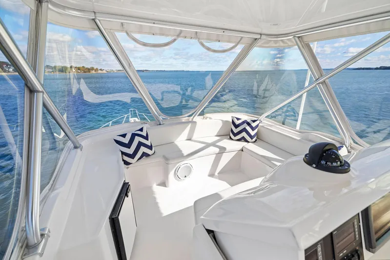 Bella Vita Yacht Photos Pics Interior view of 2010 Bertram Convertible yacht with ocean backdrop and chevron pillows.