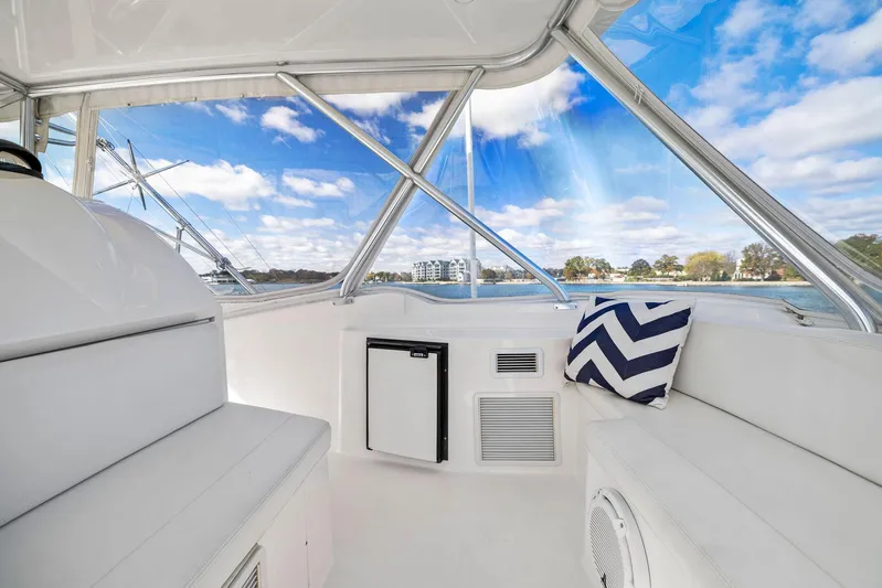 Bella Vita Yacht Photos Pics Interior of 2010 Bertram Convertible yacht with white seating and scenic view.