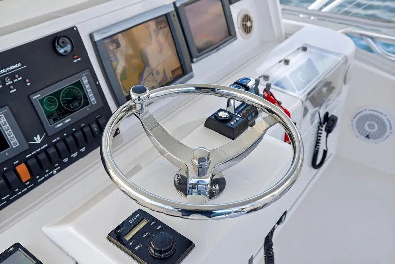 Bella Vita Yacht Photos Pics 2010 Bertram Convertible yacht helm with modern navigation controls and displays.
